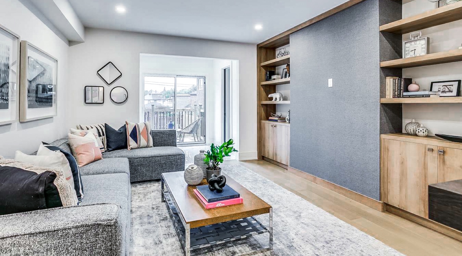 Living room with custom built-in shelving and grey feature wall